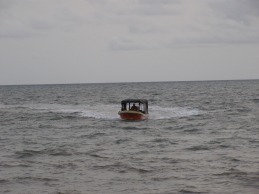 A boat approaches with departing passengers